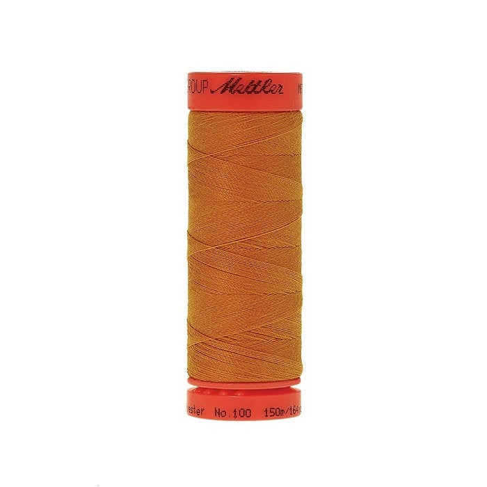 Spool of Mettler 150m orange gold thread.