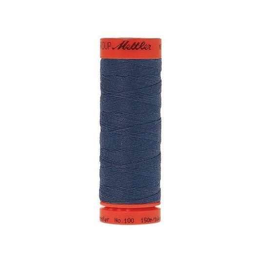 Spool of Mettler 150m dark dusky blue thread.