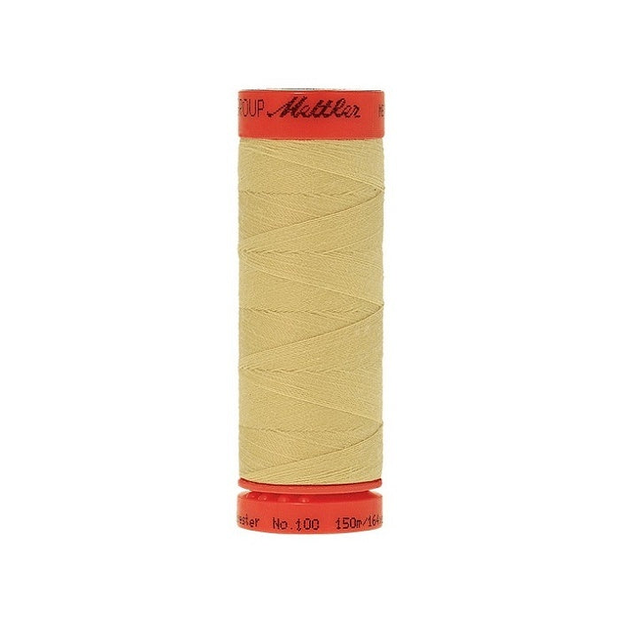Spool of Mettler 150m pale yellow thread.