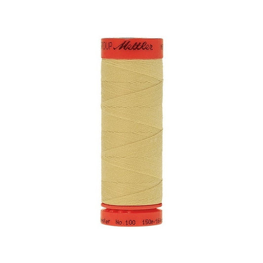 Spool of Mettler 150m pale yellow thread.