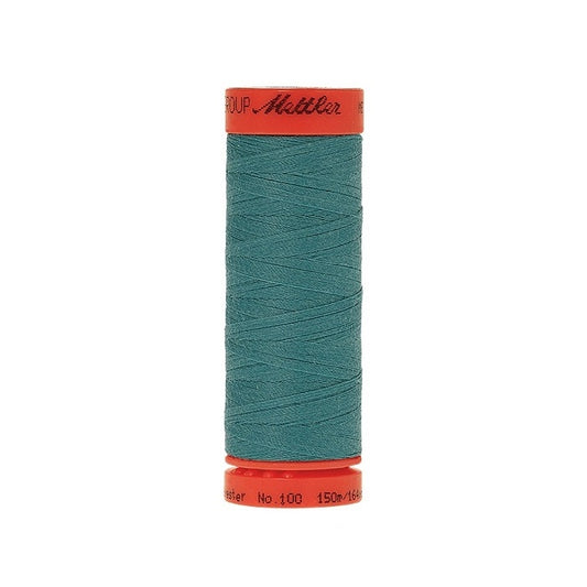 Spool of Mettler 150m teal thread.