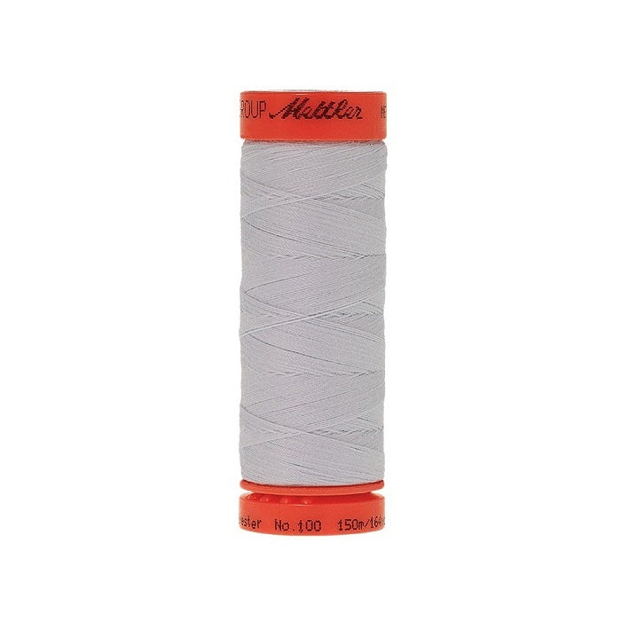 Spool of Mettler 150m light grey blue thread.