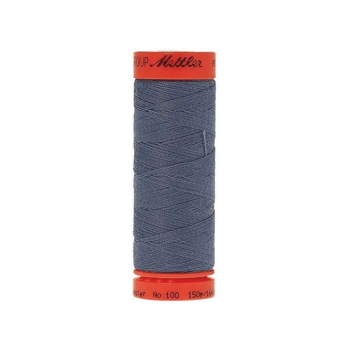 Spool of Mettler 150m dusty blue thread.