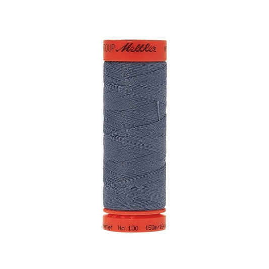Spool of Mettler 150m dusty blue thread.