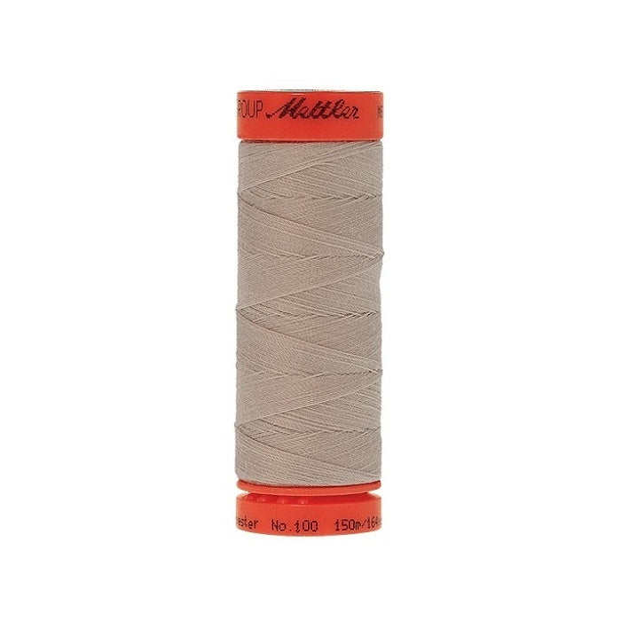 Spool of Mettler 150m light beige thread.