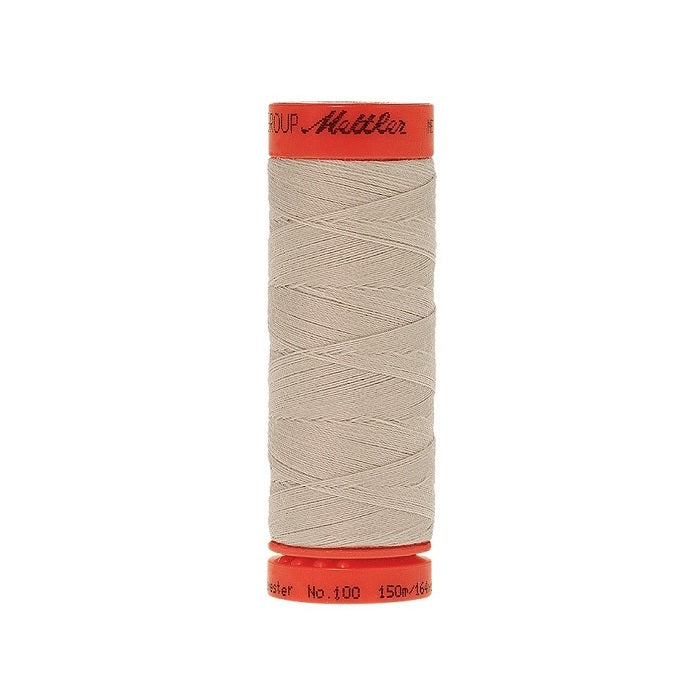 Spool of Mettler 150m beige thread.