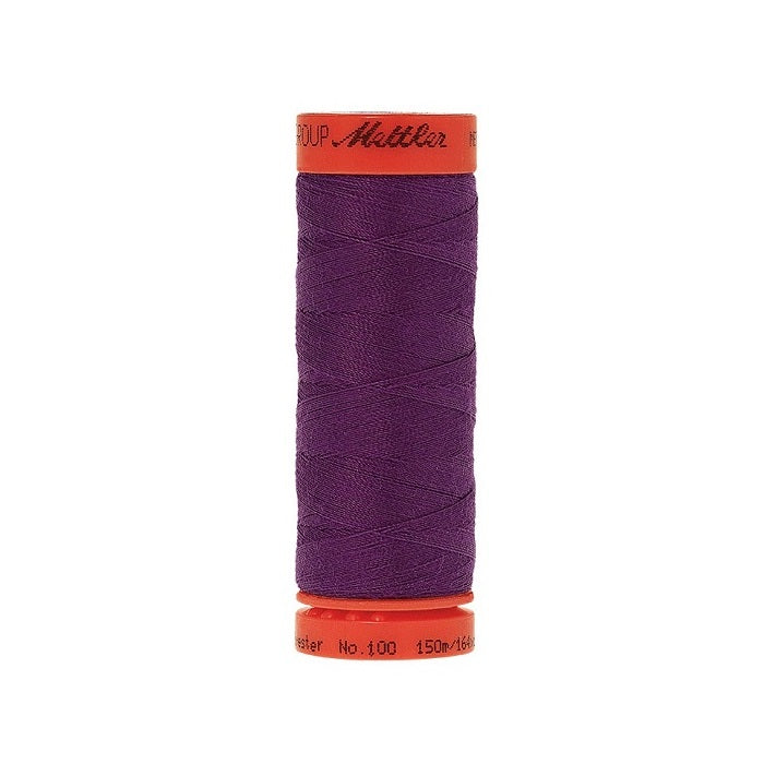 Spool of Mettler 150m grape purple thread.