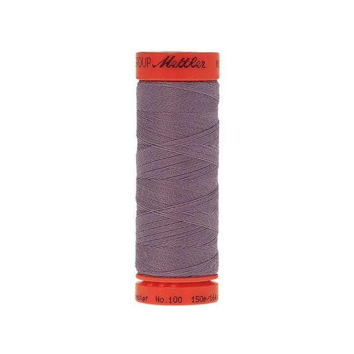 Spool of Mettler 150m purple grey thread.