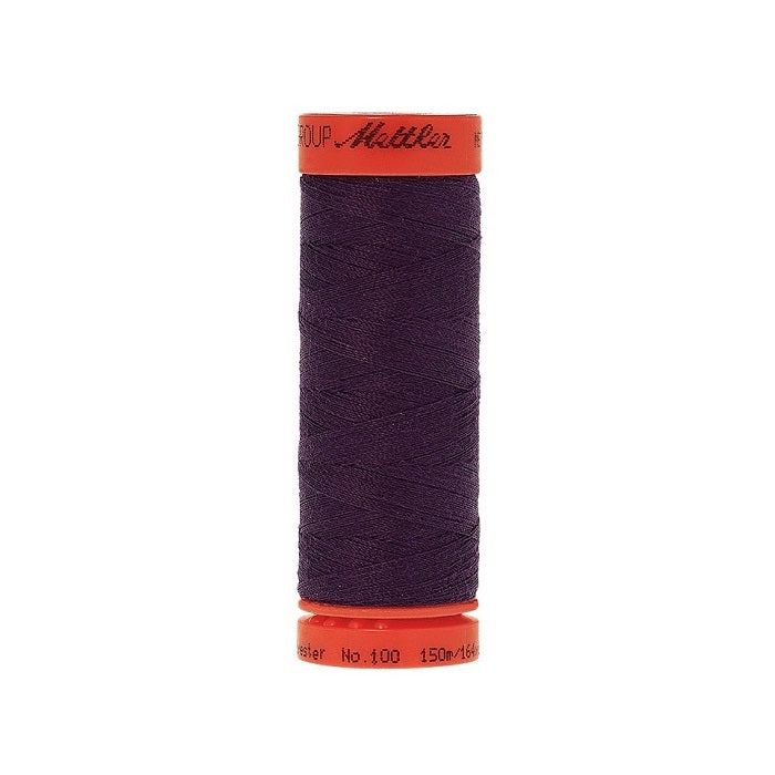 Spool of Mettler 150m dark purple thread.