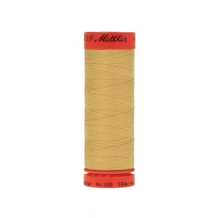 Spool of Mettler 150m dusky yellow thread.