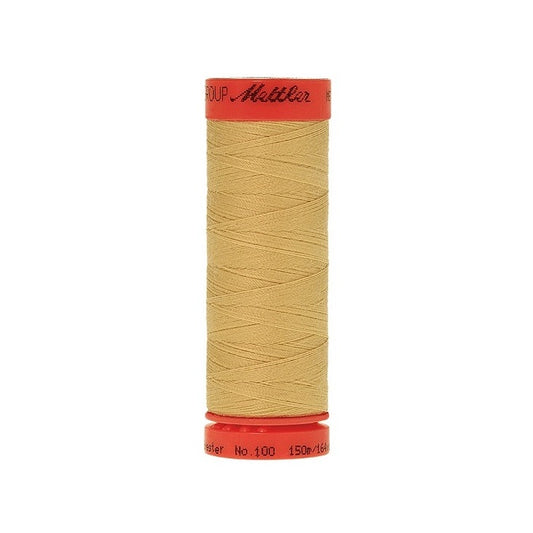 Spool of Mettler 150m dusky yellow thread.