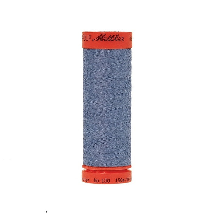 Spool of Mettler 150m dusky blue thread.