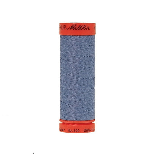 Spool of Mettler 150m dusky blue thread.