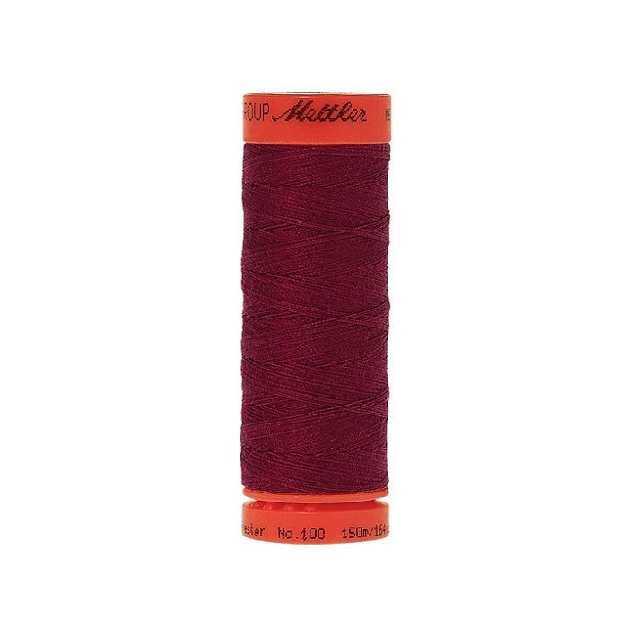 Spool of Mettler 150m dark red thread.
