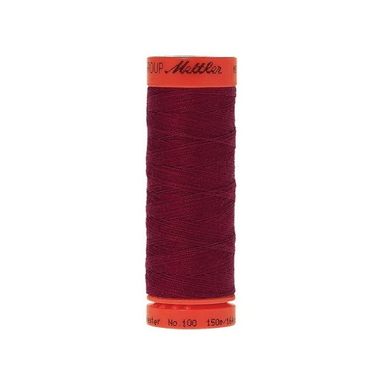 Spool of Mettler 150m dark red thread.