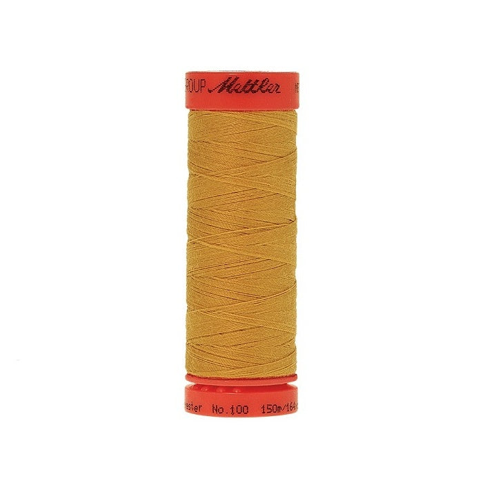 Spool of Mettler 150m mustard thread.