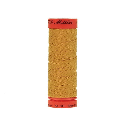 Spool of Mettler 150m mustard thread.