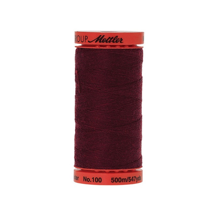 Spool of Mettler 500m burgundy thread.