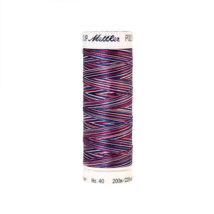 Spool of Mettler red and blue variegated thread.