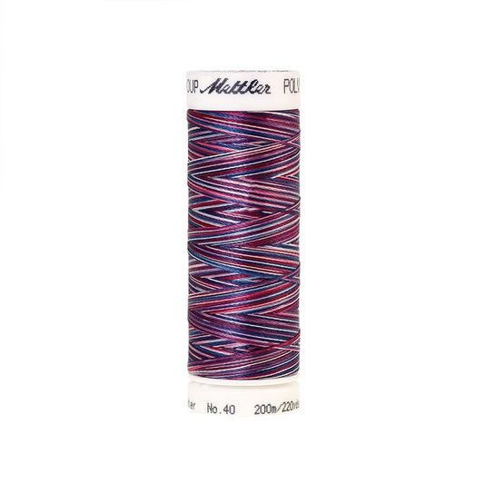 Spool of Mettler red and blue variegated thread.