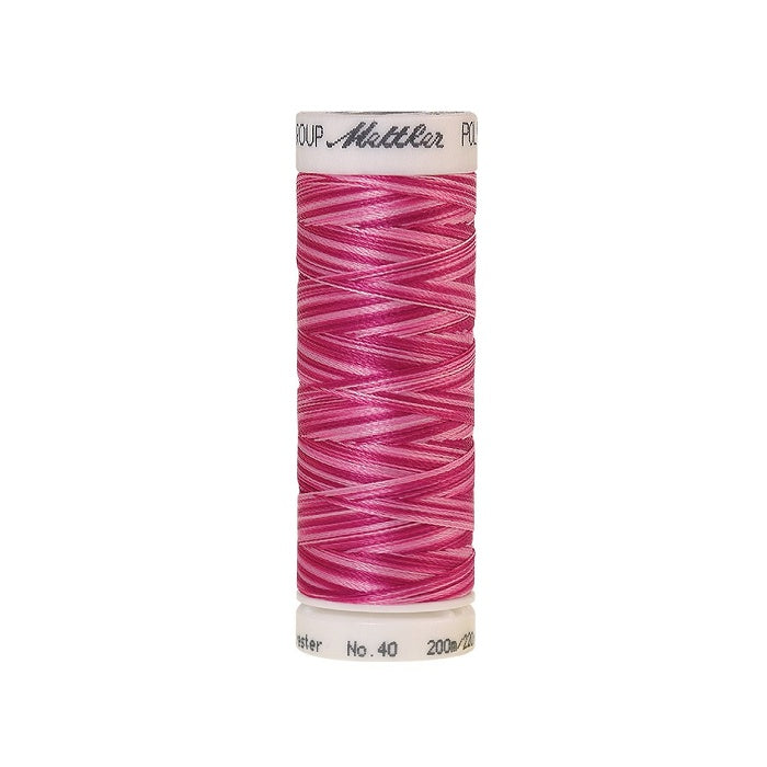 Spool of Mettler pink variegated thread.