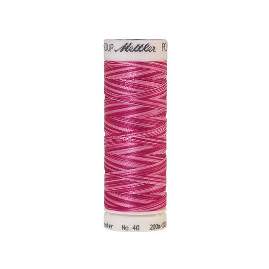 Spool of Mettler pink variegated thread.