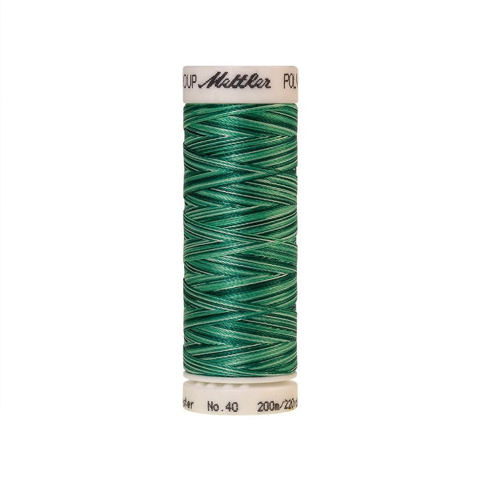 Spool of Mettler green variegated thread.