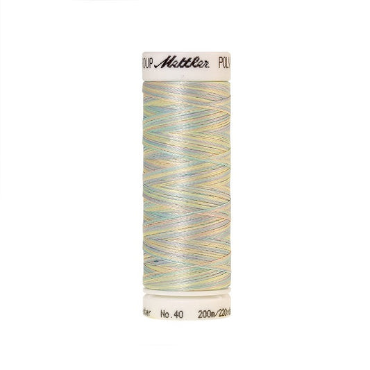Spool of Mettler light pink green and yellow variegated thread.