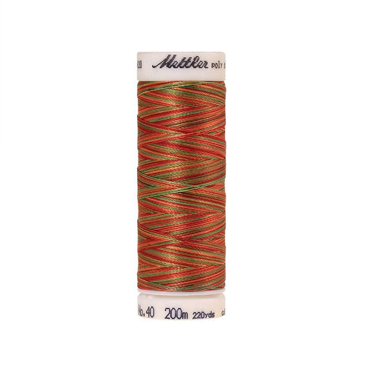 Spool of Mettler green and orange variegated thread.