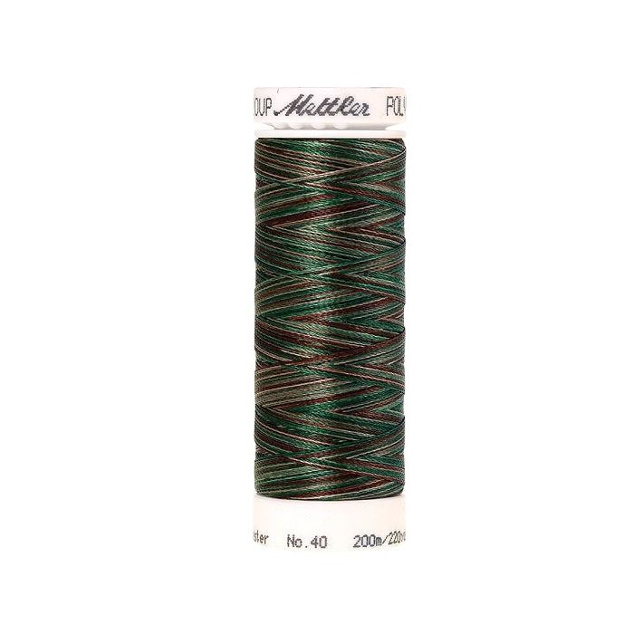 Spool of Mettler green and brown variegated thread.