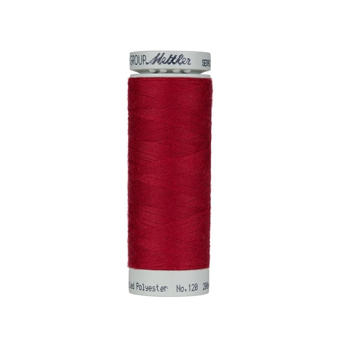 Spool of red thread with Mettler Seracycle branding.