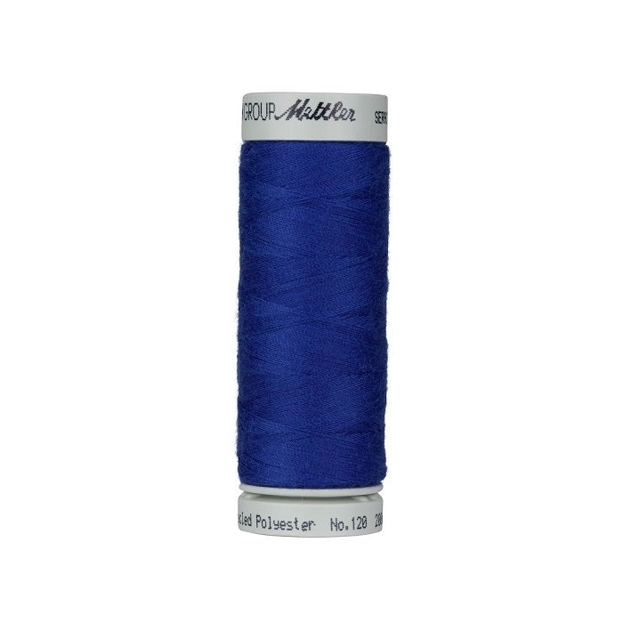 Spool of dark blue thread with Mettler Seracycle branding.