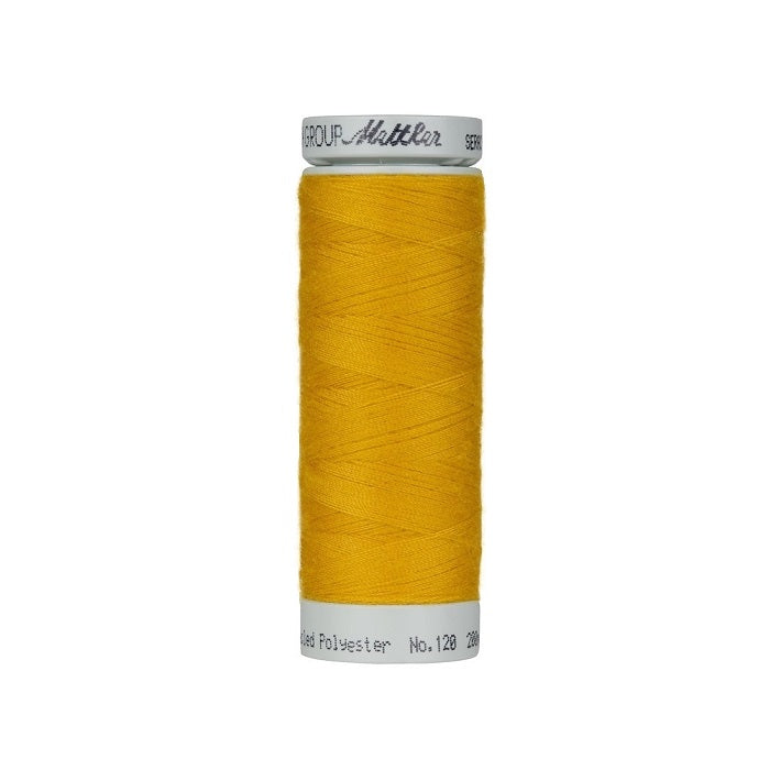 Spool of gold thread with Mettler Seracycle branding.
