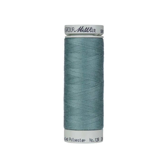 Spool of teal blue thread with Mettler Seracycle branding.