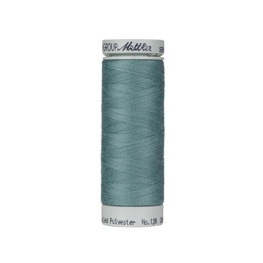 Spool of teal blue thread with Mettler Seracycle branding.