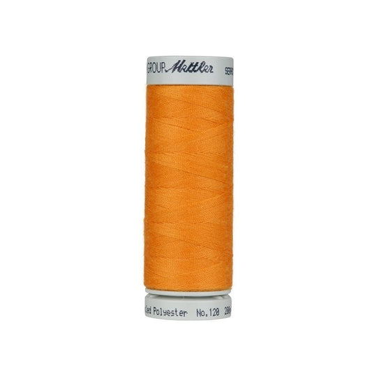 Spool of orange thread with Mettler Seracycle branding.
