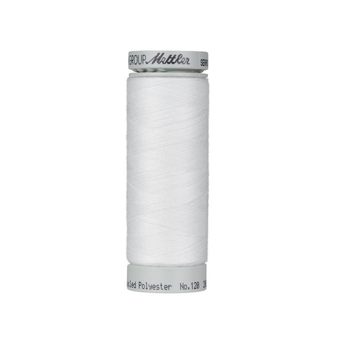 Spool of white thread with Mettler Seracycle branding.
