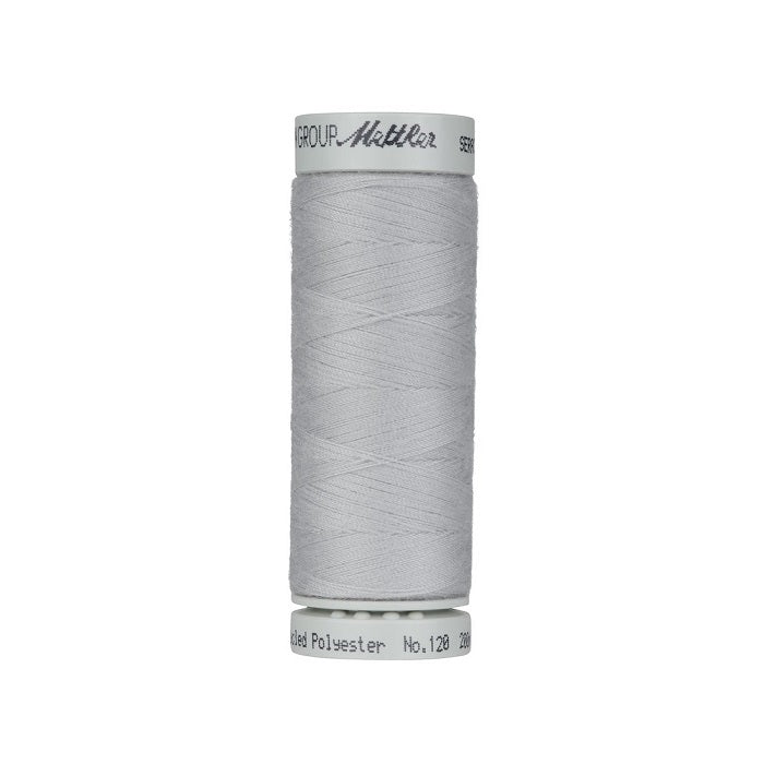 Spool of grey thread with Mettler Seracycle branding.