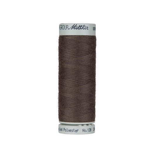 Spool of dark brown thread with Mettler Seracycle branding.