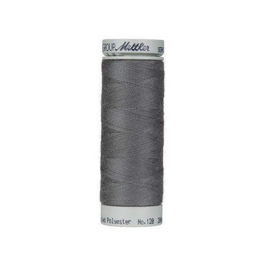 Spool of dark siilver grey thread with Mettler Seracycle branding.