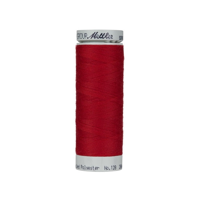 Spool of red thread with Mettler Seracycle branding.