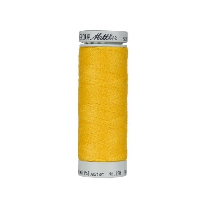Spool of yellow thread with Mettler Seracycle branding.