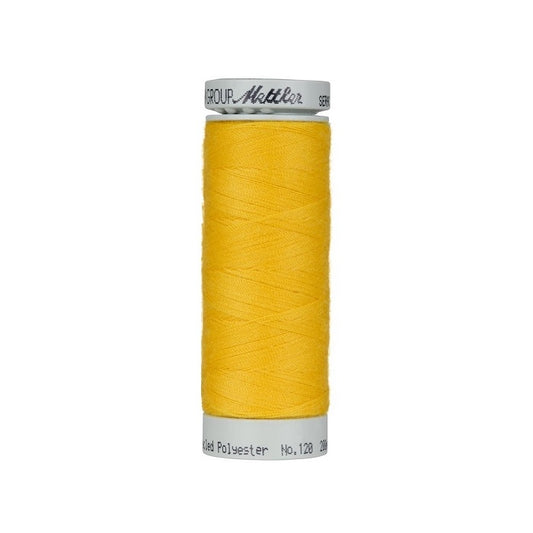 Spool of yellow thread with Mettler Seracycle branding.