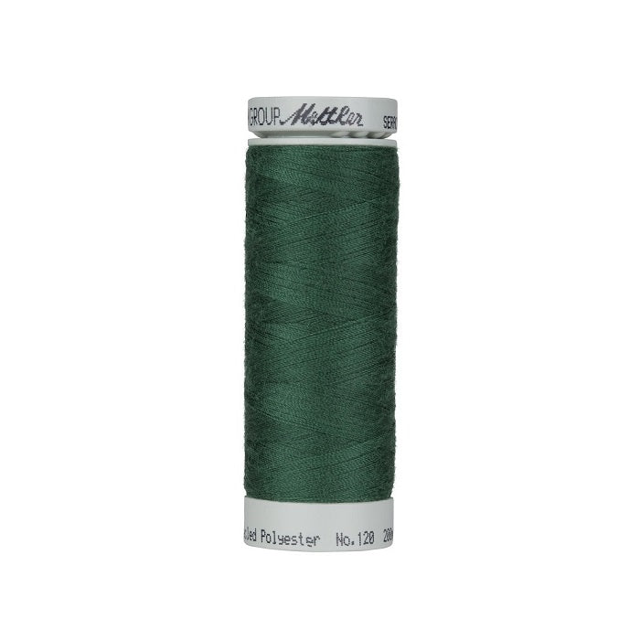 Spool of dark green thread with Mettler Seracycle branding.