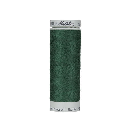 Spool of dark green thread with Mettler Seracycle branding.
