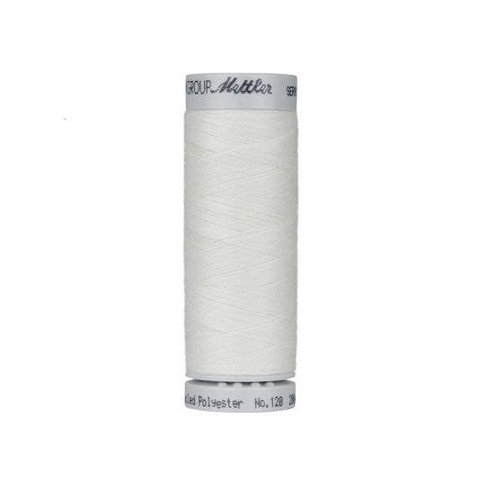 Spool of natural thread with Mettler Seracycle branding.