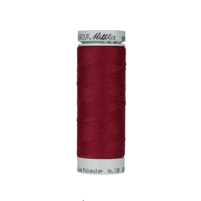 Spool of cranberry red thread with Mettler Seracycle branding.