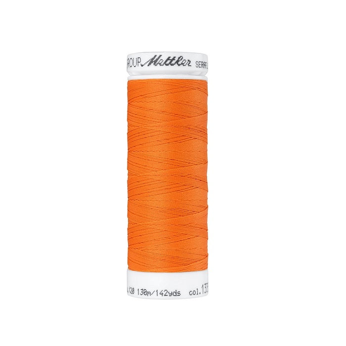 Spool of bright orange thread with Mettler Seraflex branding.