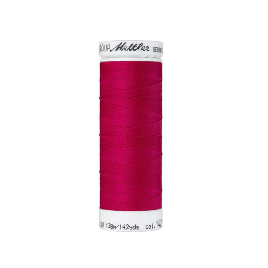Spool of dark pink thread with Mettler Seraflex branding.
