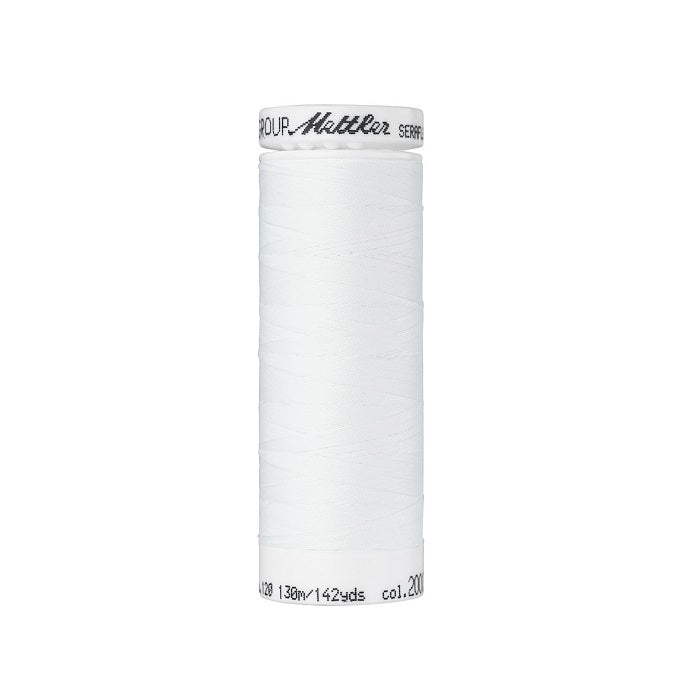 Spool of white thread with Mettler Seraflex branding.